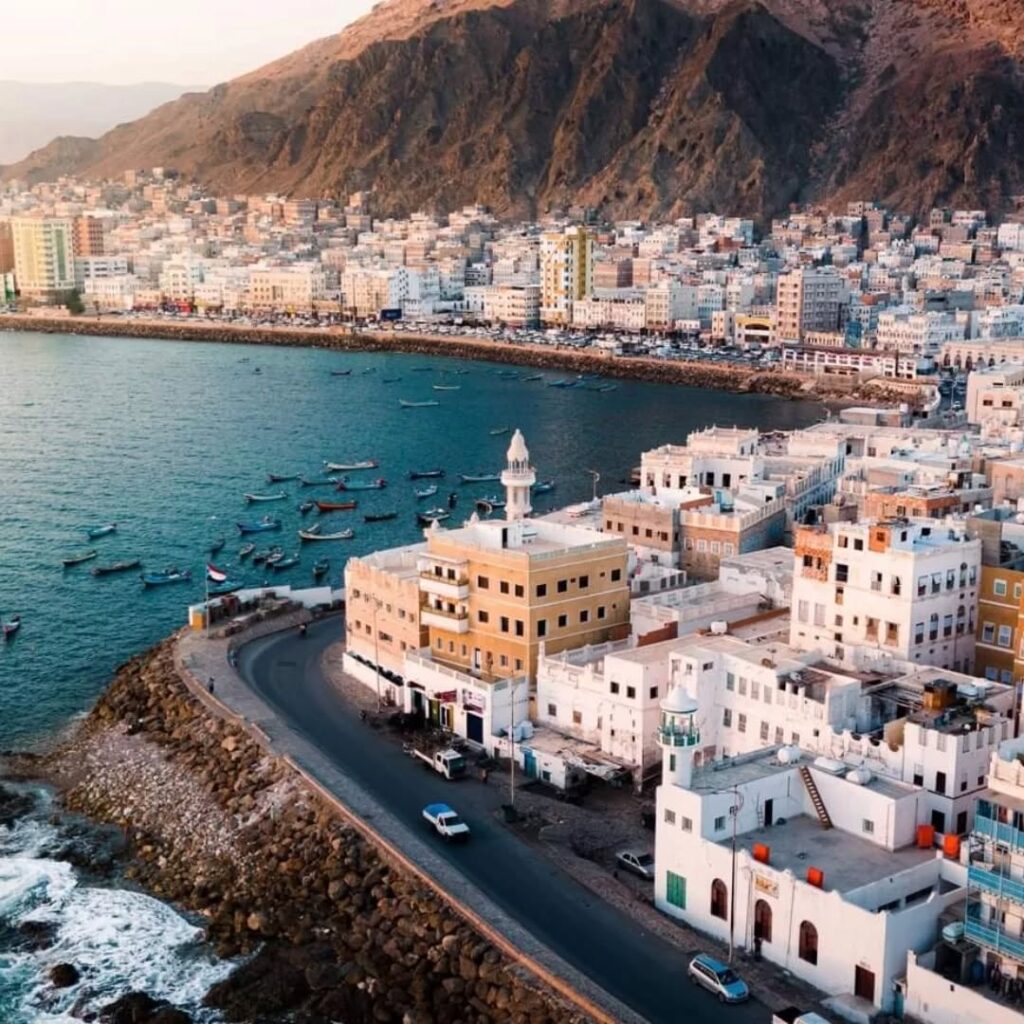 Old Al Mukalla Corniche featuring traditional fishing boats and white buildings